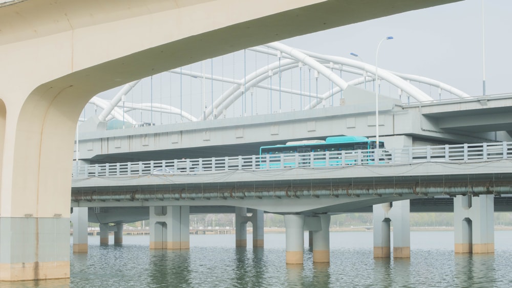 a bridge over a body of water with a bus on it