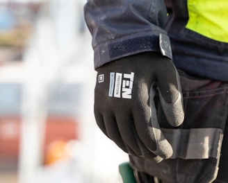 a person wearing a safety jacket and gloves