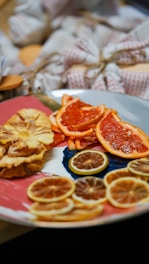 Assortment of dried citrus fruits displayed on a rustic slate board.