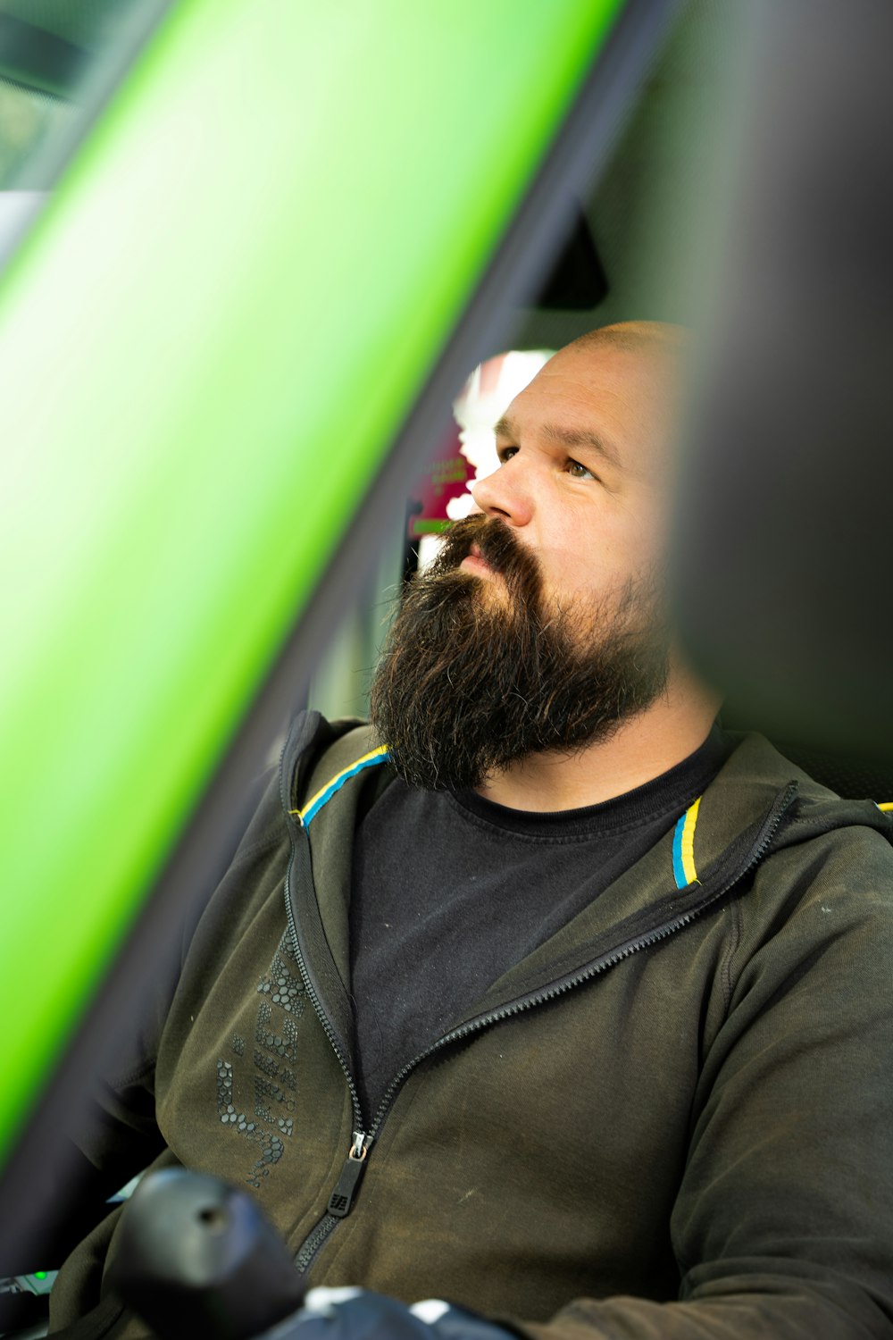 a man with a beard sitting in a car