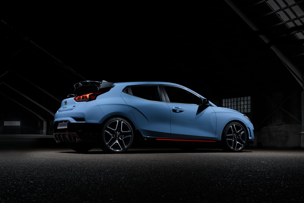 a blue car parked in a dark garage