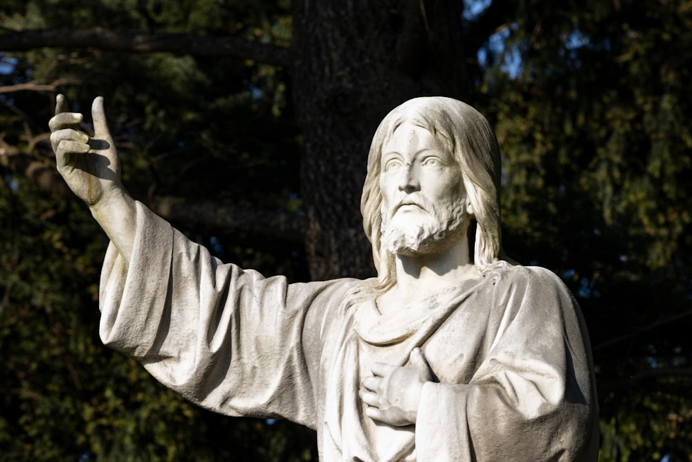 a statue of jesus holding a peace sign