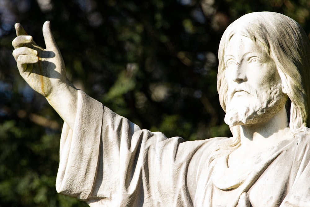 a statue of jesus holding a peace sign