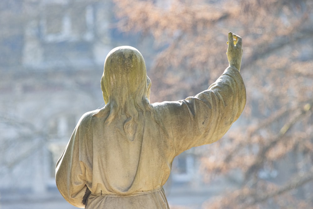 a statue of a person with a bird in their hand