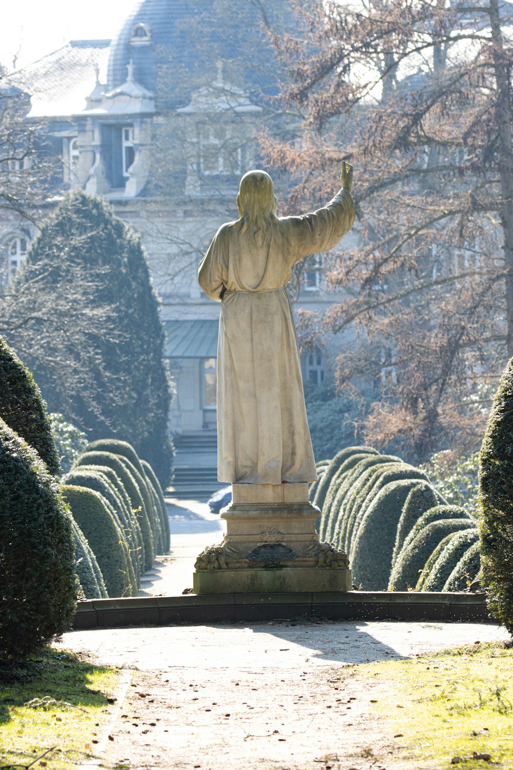 a statue of jesus in front of a building