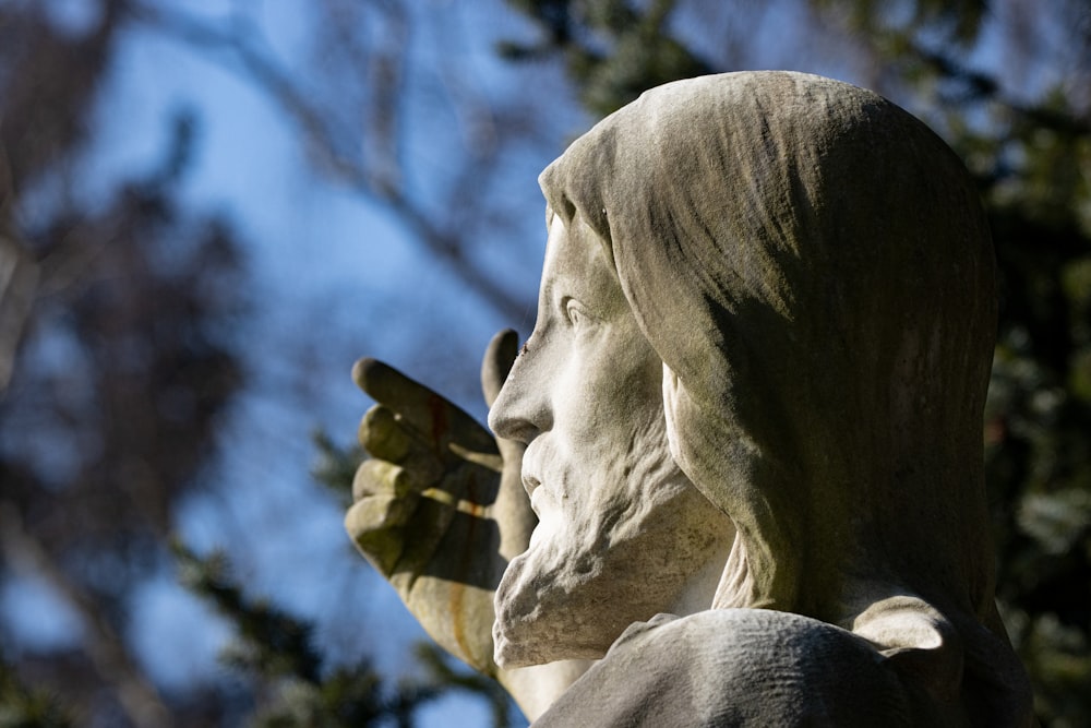 a statue of a woman holding a cell phone