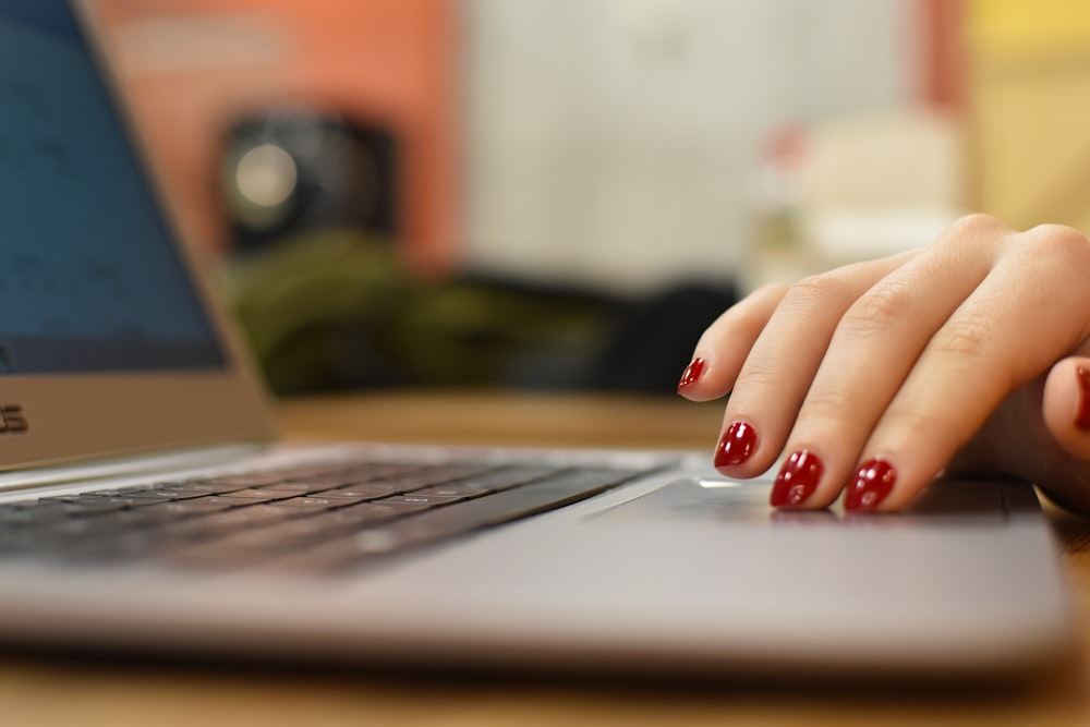 a close up of a person's hand on a laptop