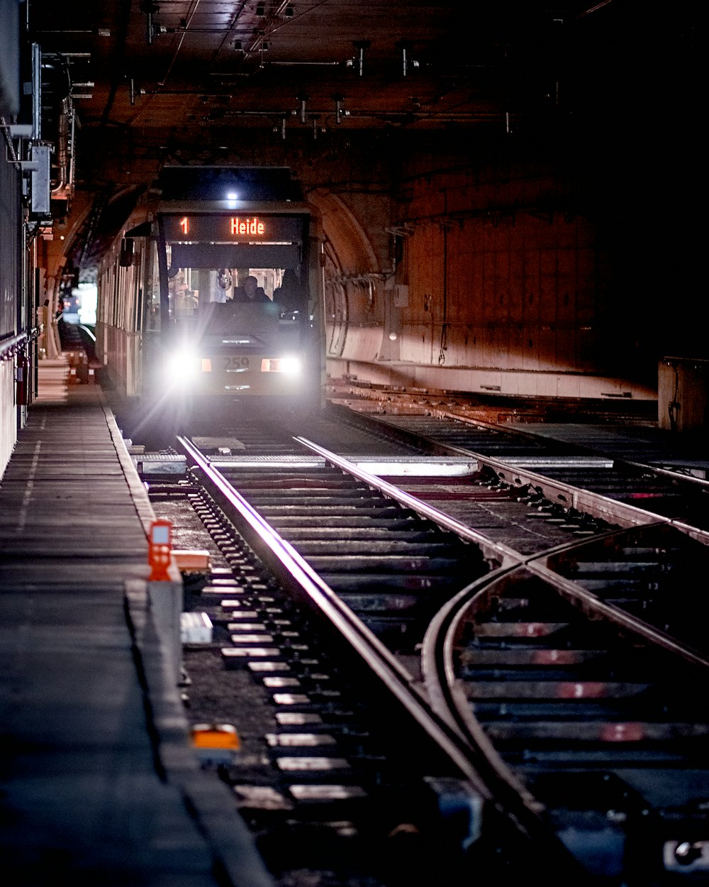 a train is coming down the tracks in the dark