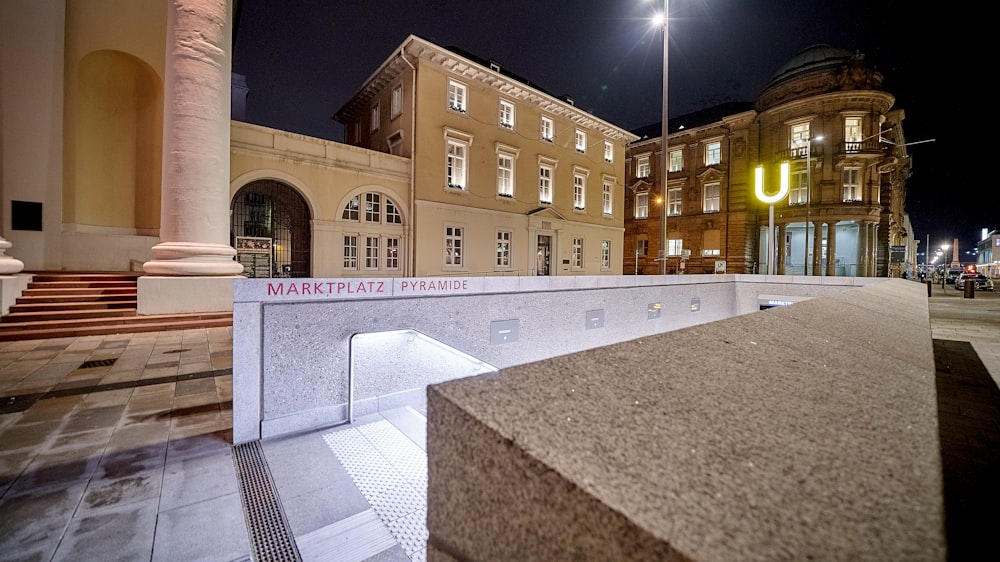 a large building with a lit up sign on the side of it