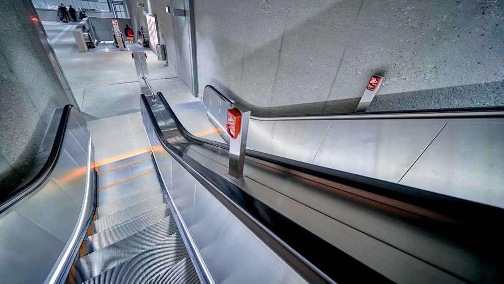 an escalator in a building with metal railings