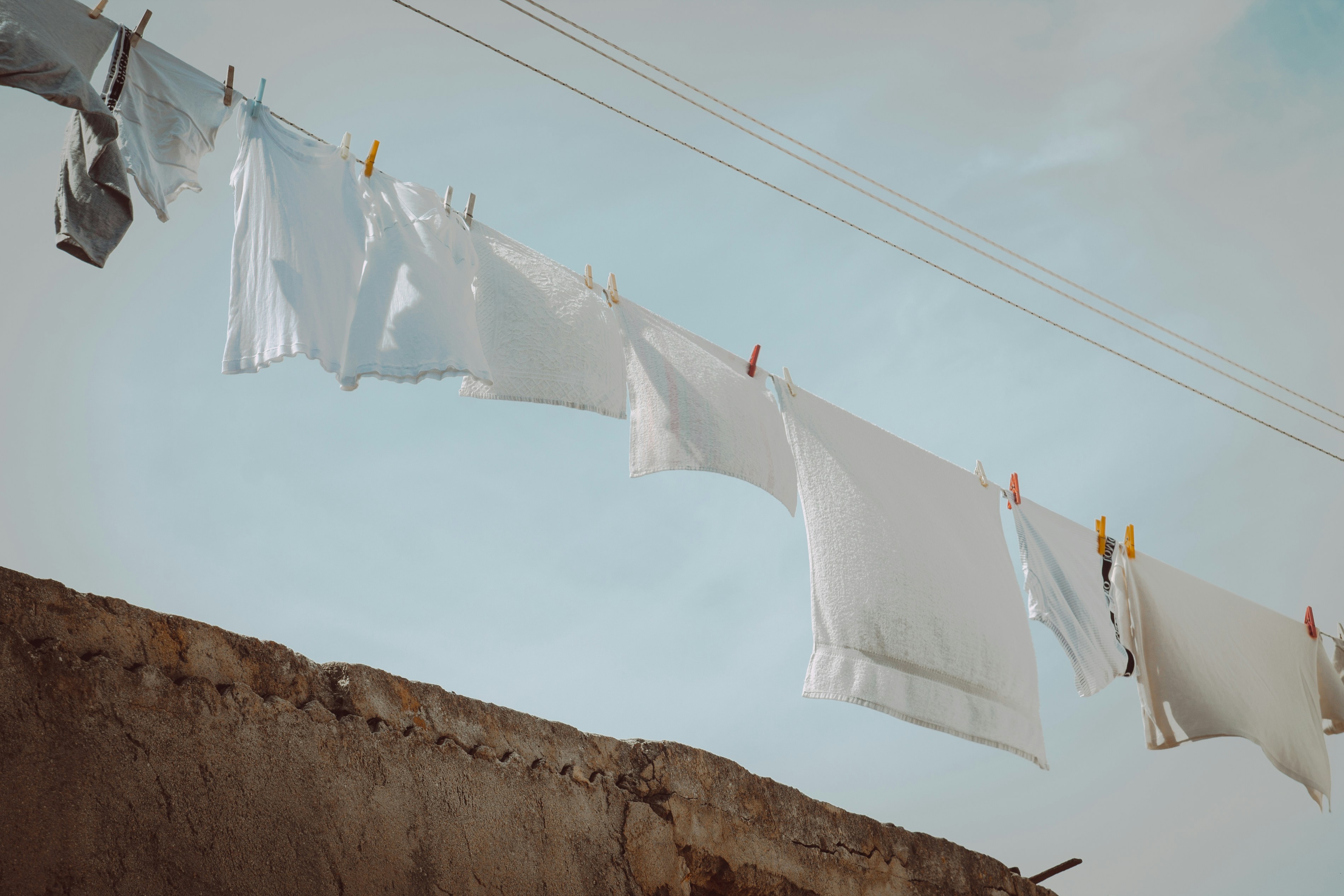A line of clothes hanging on a clothes line photo Free Briatico Image