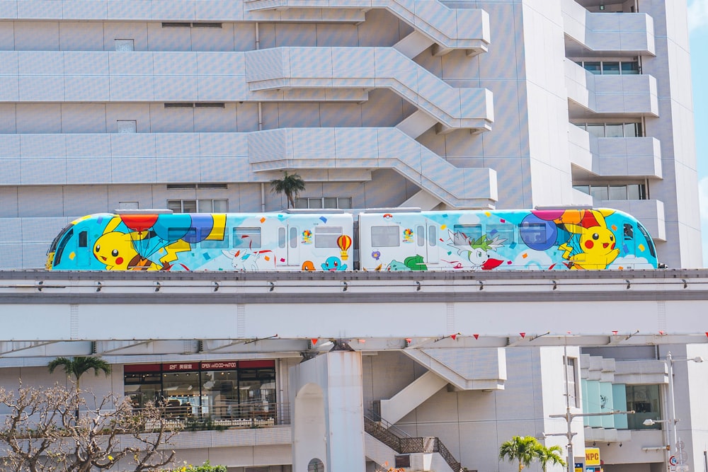 a colorful train is going over a bridge