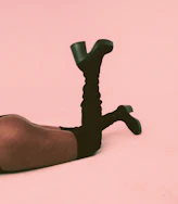 a person laying on the ground with their legs crossed
