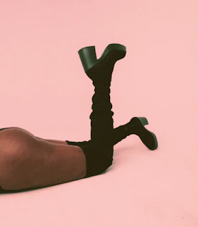 a person laying on the ground with their legs crossed
