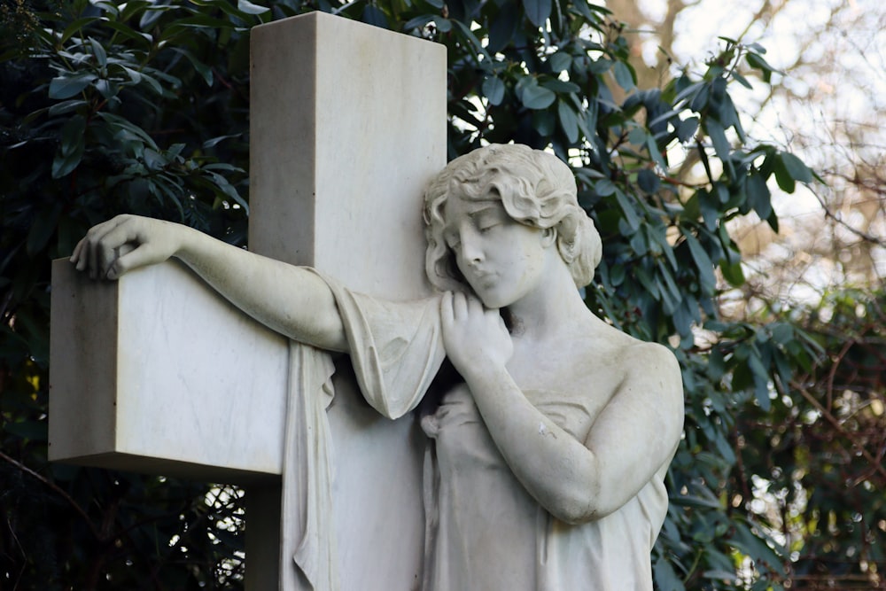 a statue of a woman holding a cross