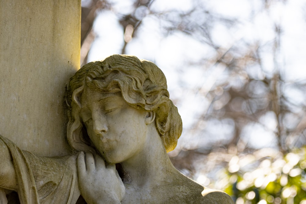 a close up of a statue on a pillar