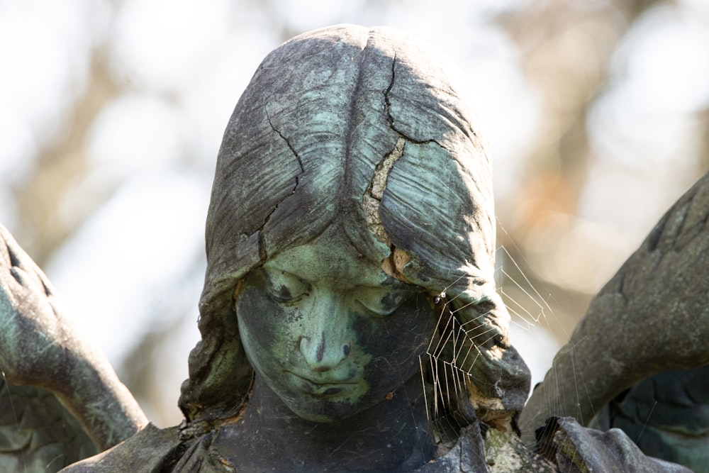 a statue of a woman with her hands on her head