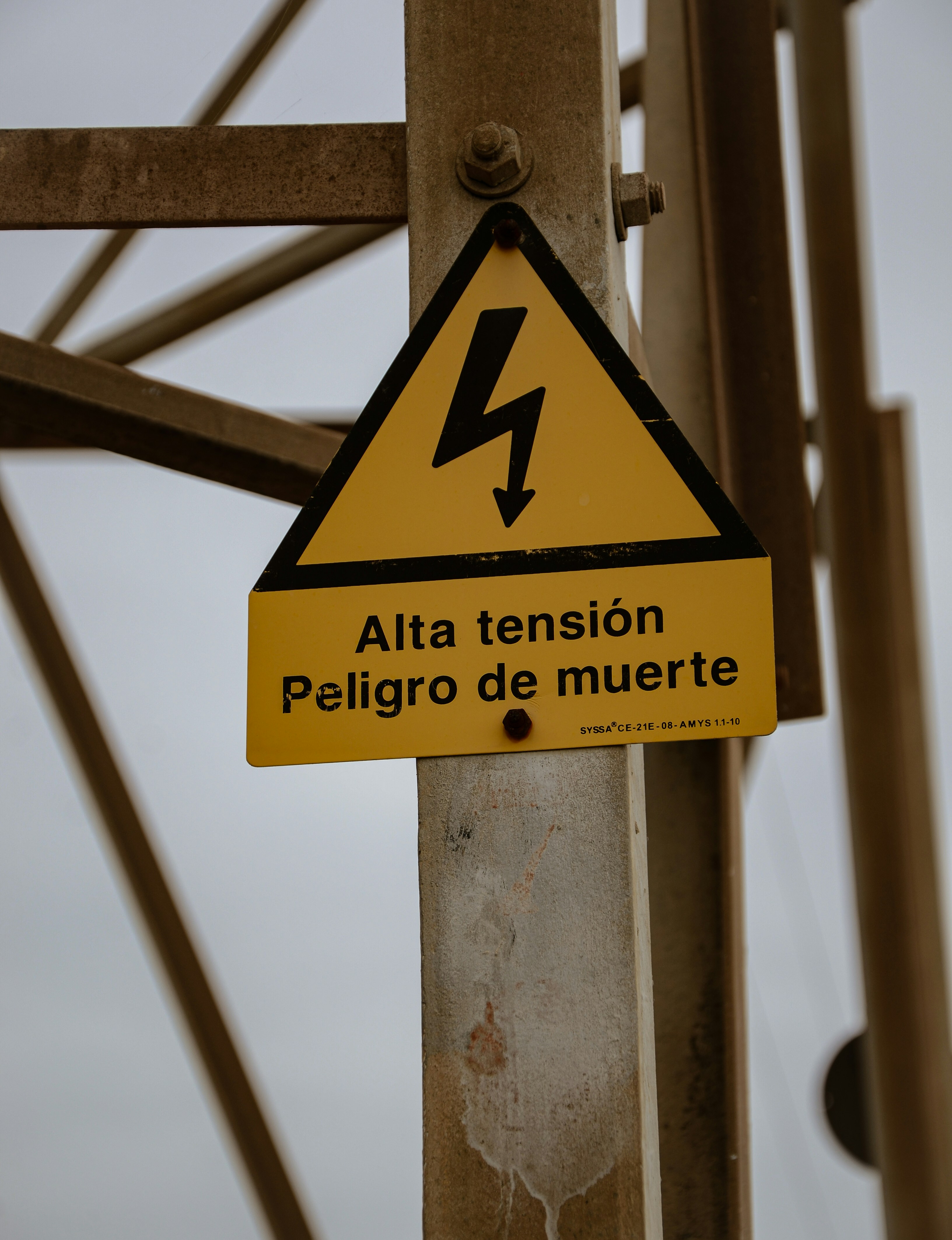 a yellow and black sign that is on a pole
