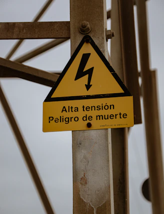 a yellow and black sign that is on a pole