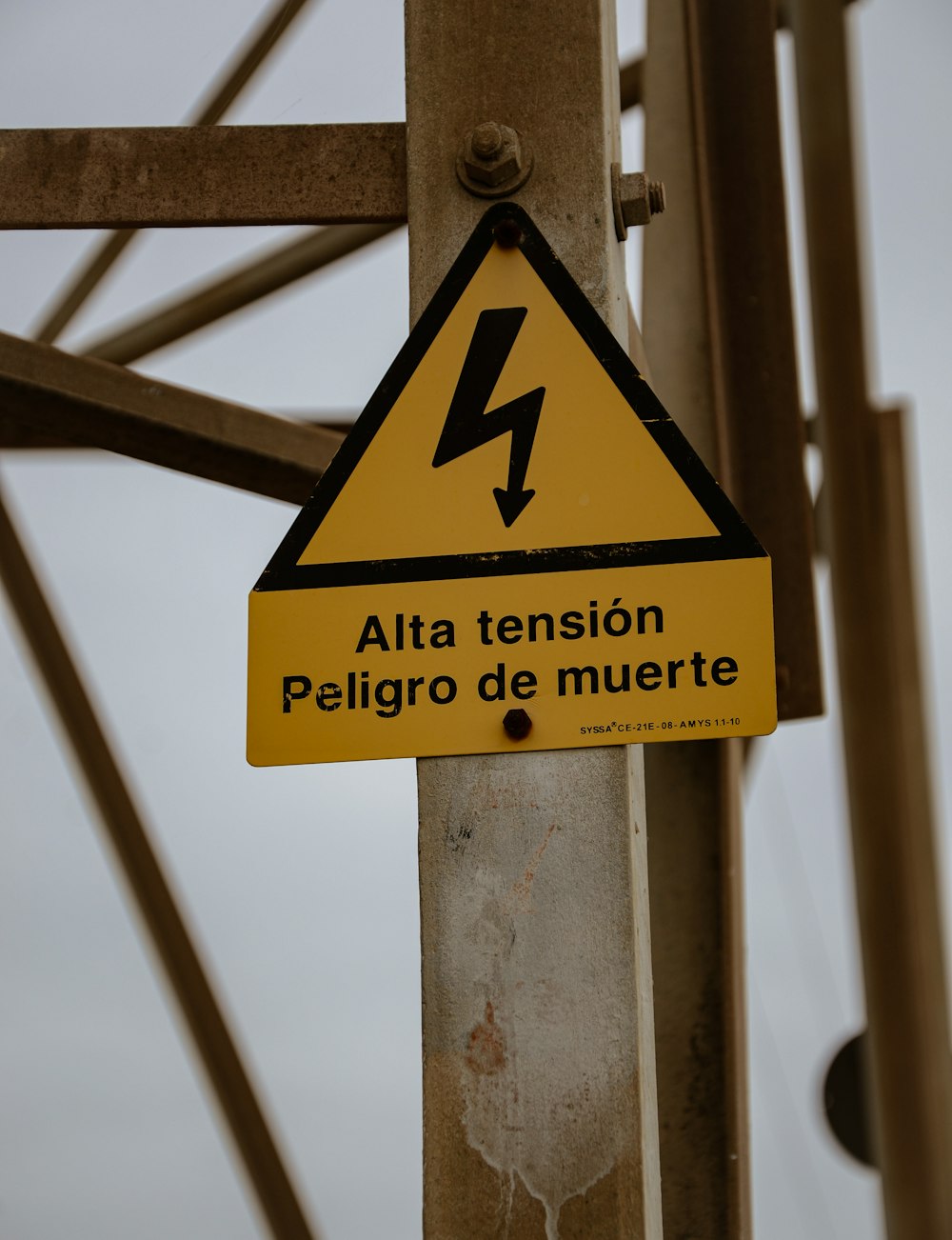 a yellow and black sign that is on a pole