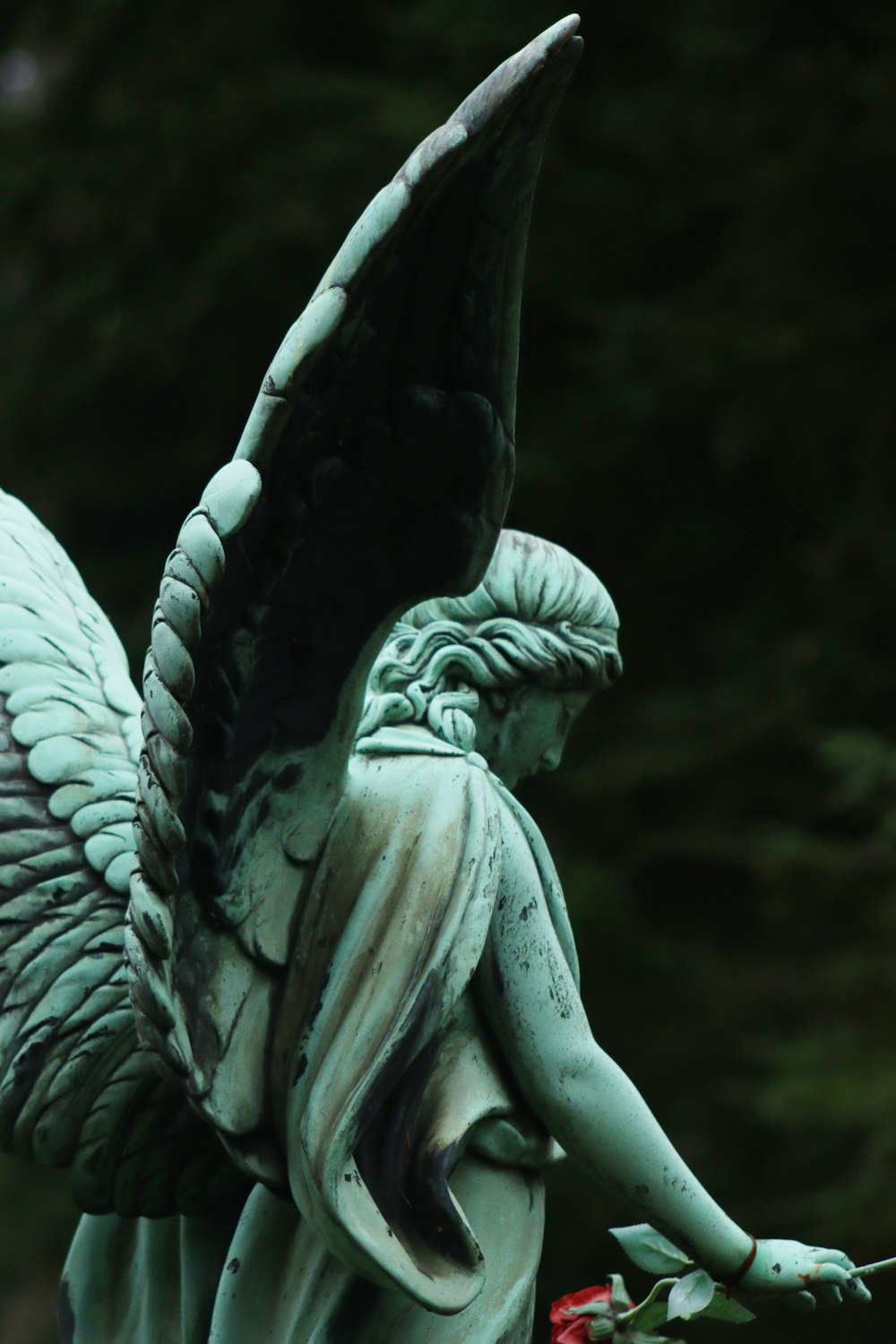 a statue of an angel holding a rose