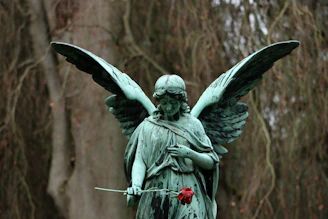 a statue of an angel holding a rose