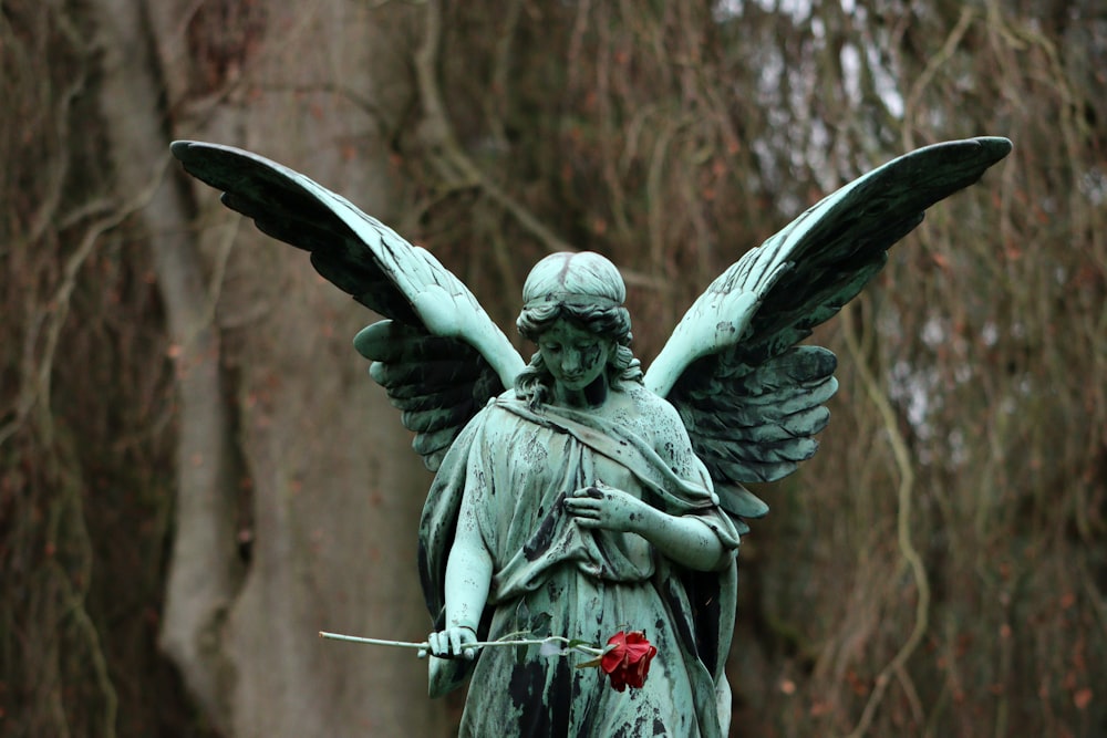 a statue of an angel holding a rose