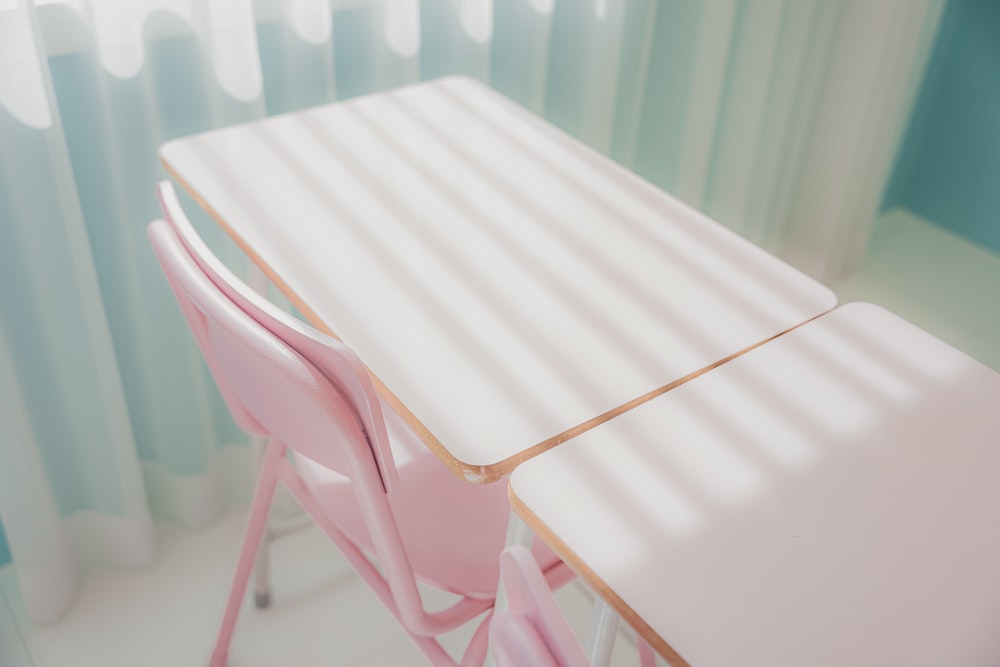 a pink table and chairs in a room