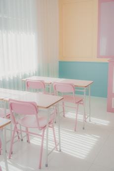 a room that has a bunch of pink chairs in it