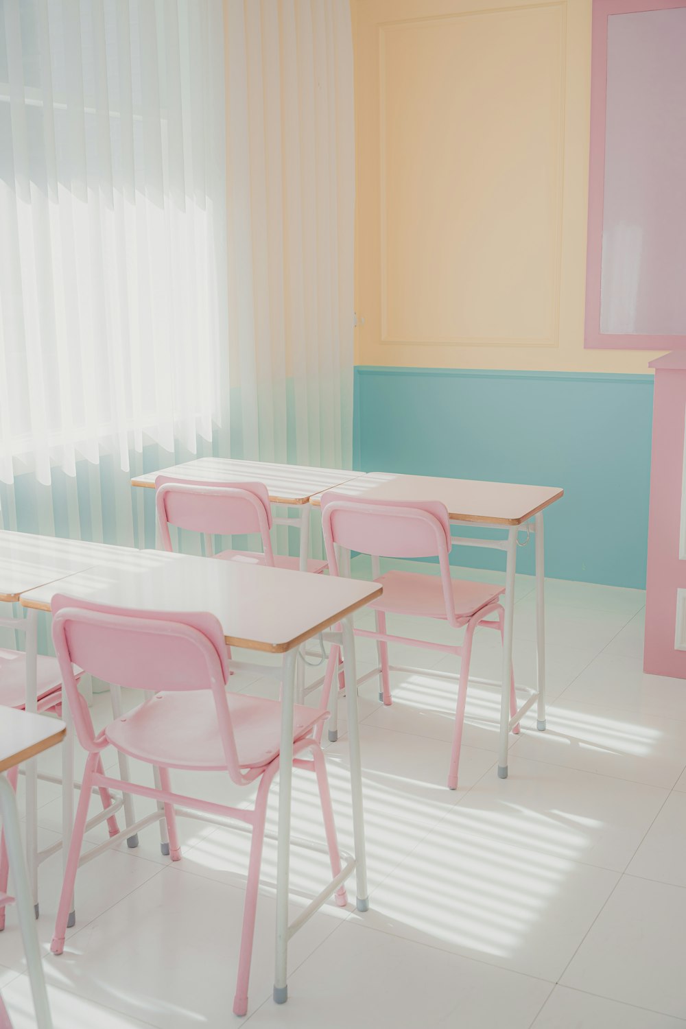a room that has a bunch of pink chairs in it