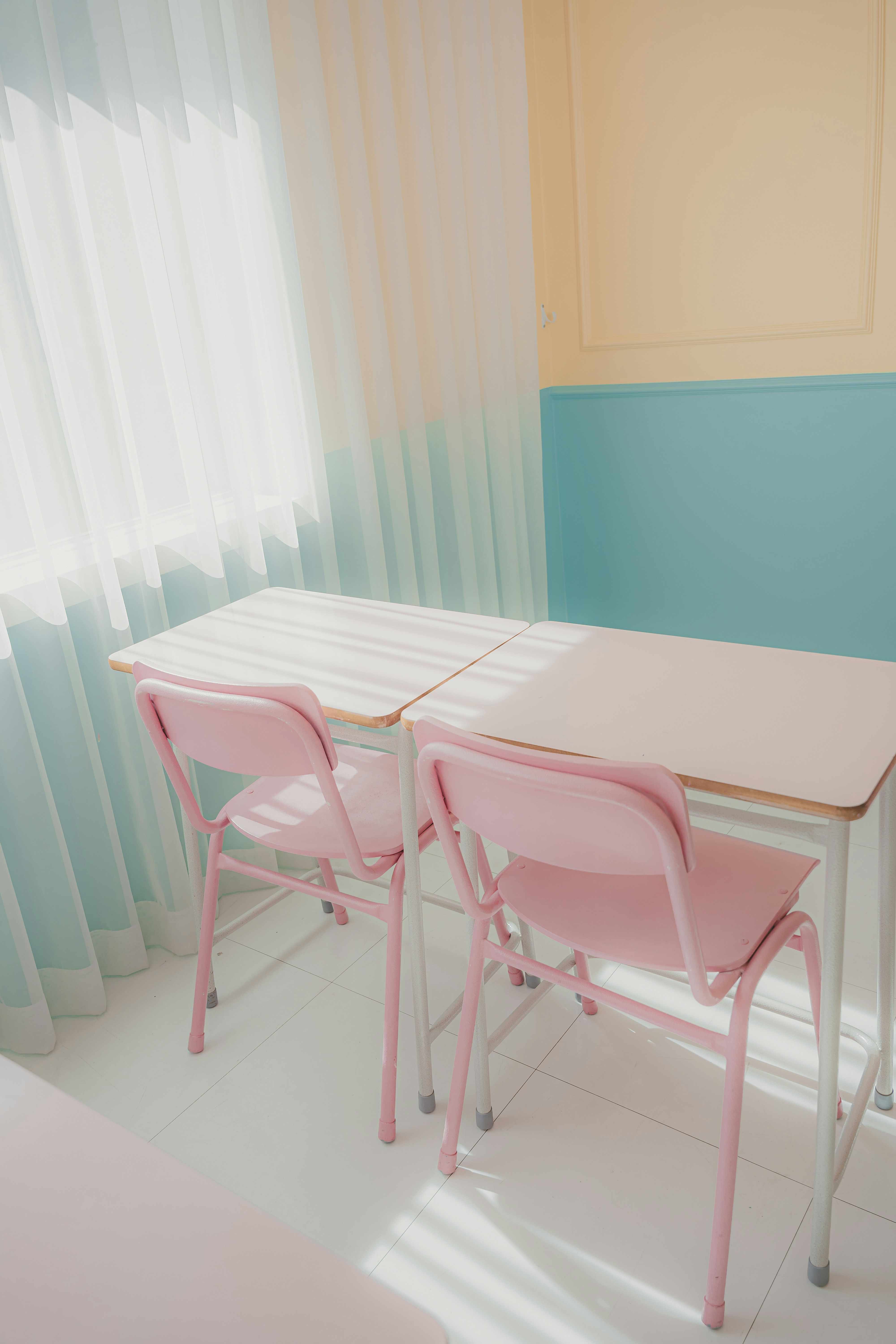 a pink table and two pink chairs in a room