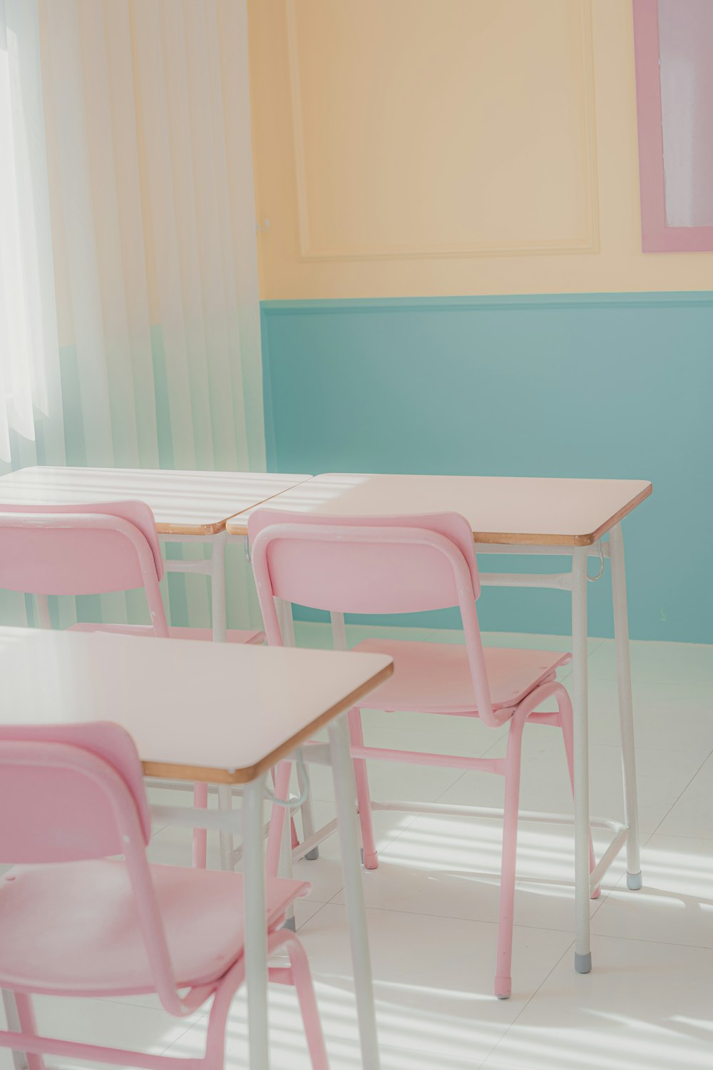 a row of pink chairs sitting next to a table