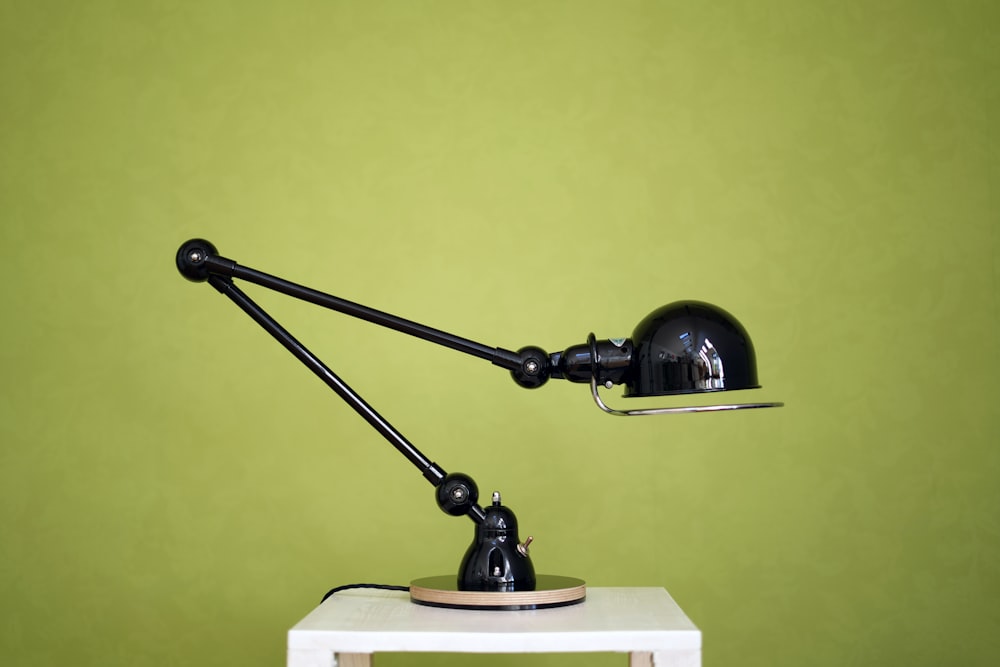 a desk lamp sitting on top of a white table