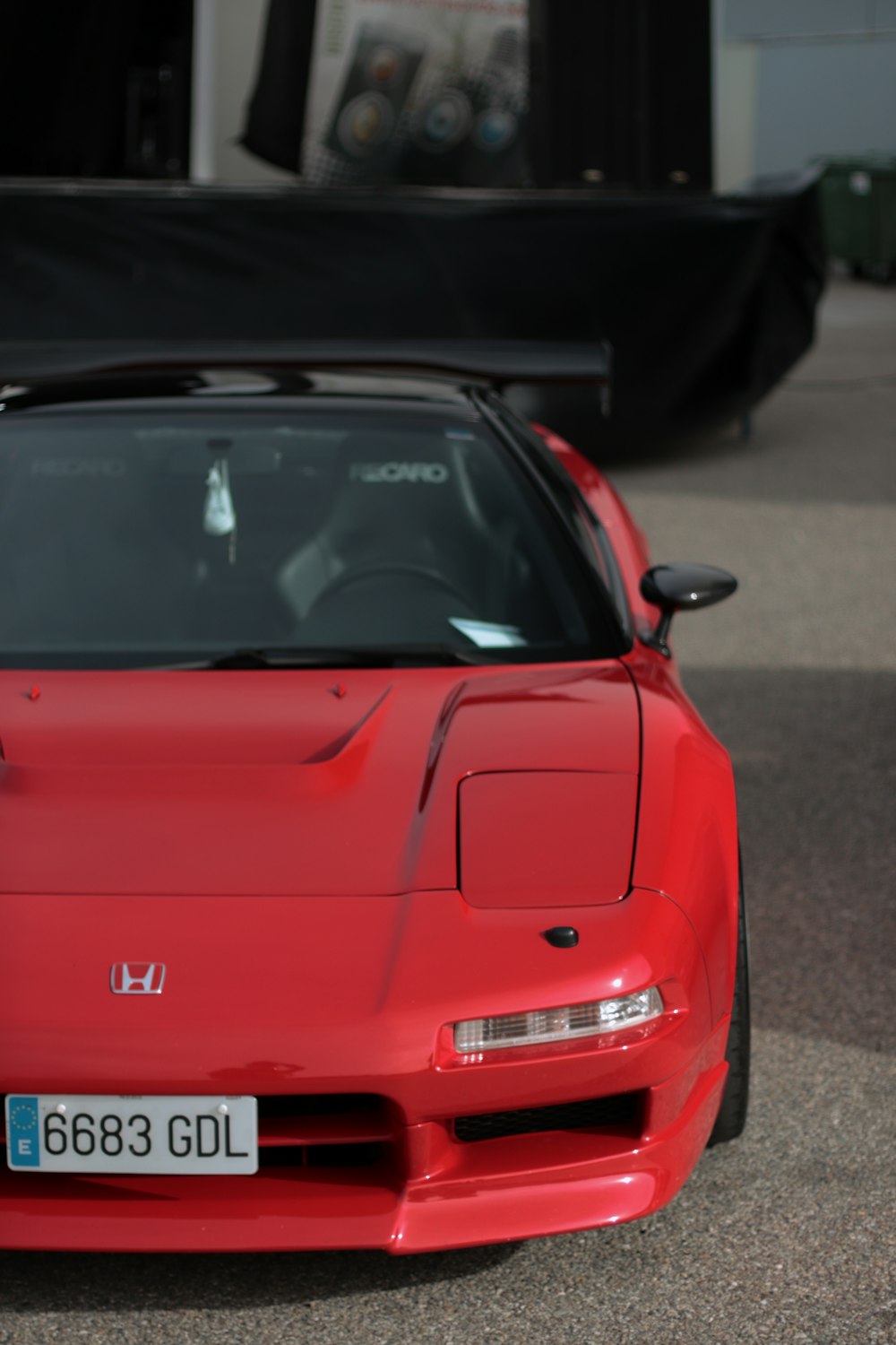 a red sports car parked in a parking lot