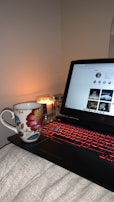 A cozy online shopping setup with a laptop and coffee.