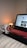 A cozy home setting with a laptop open to an online shopping site.