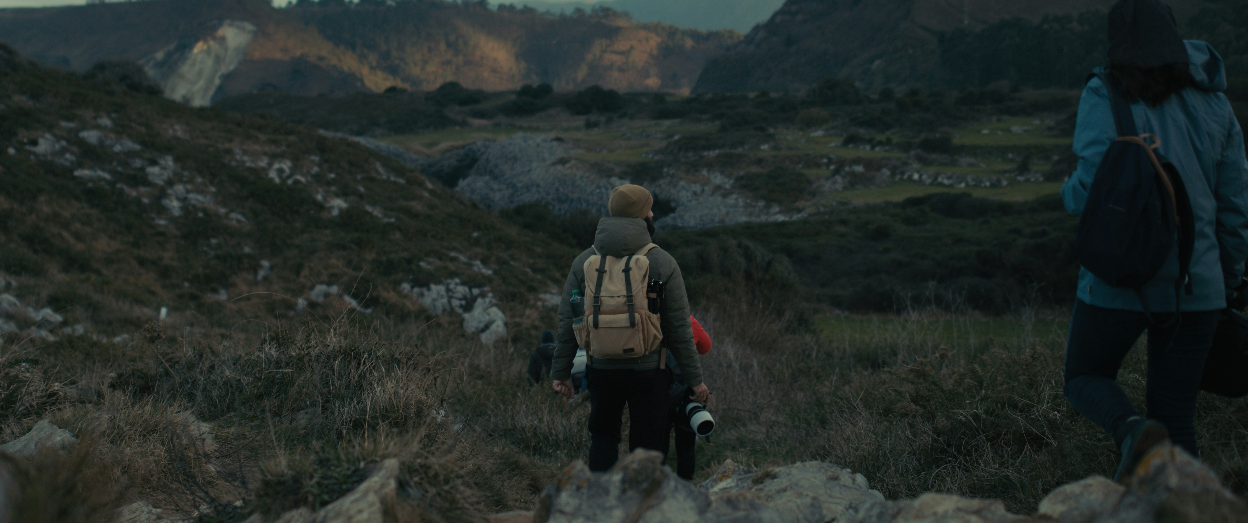 a couple of people walking up a hill