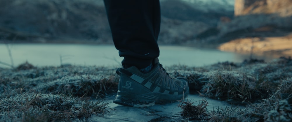 a person standing in the snow with their feet on the ground