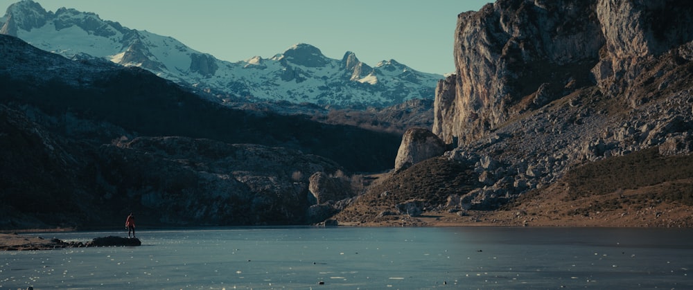 a person standing on the edge of a body of water