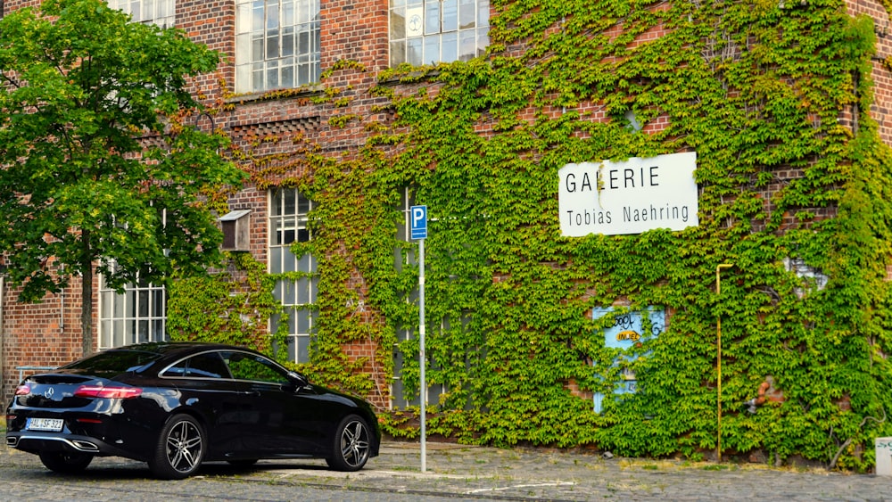 a black car parked in front of a building