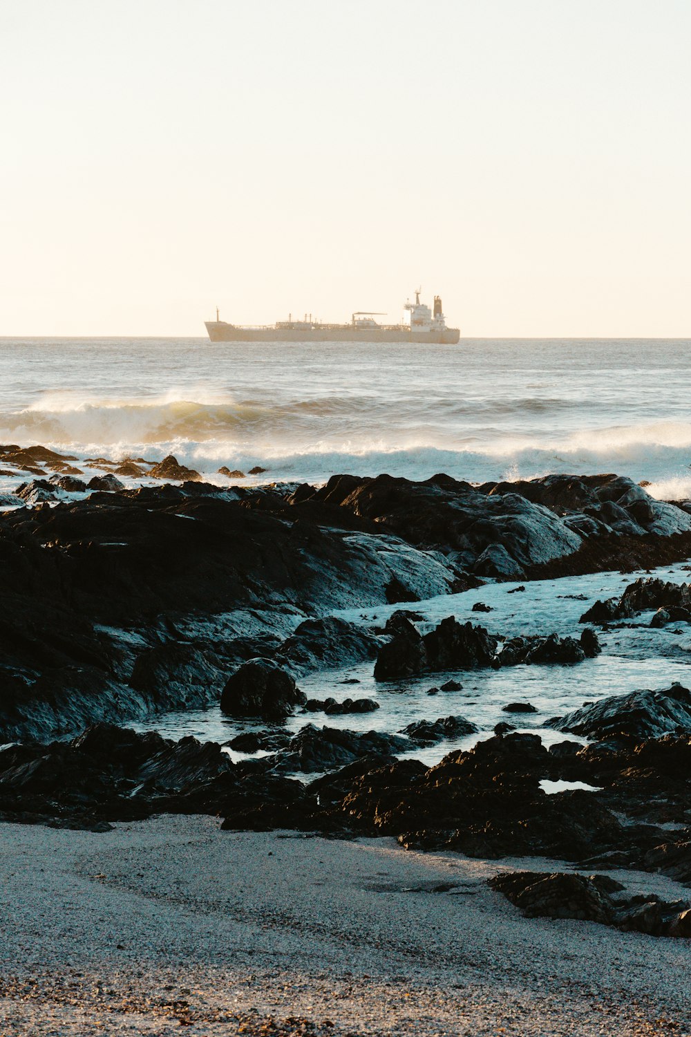 a large ship is in the distance on the ocean