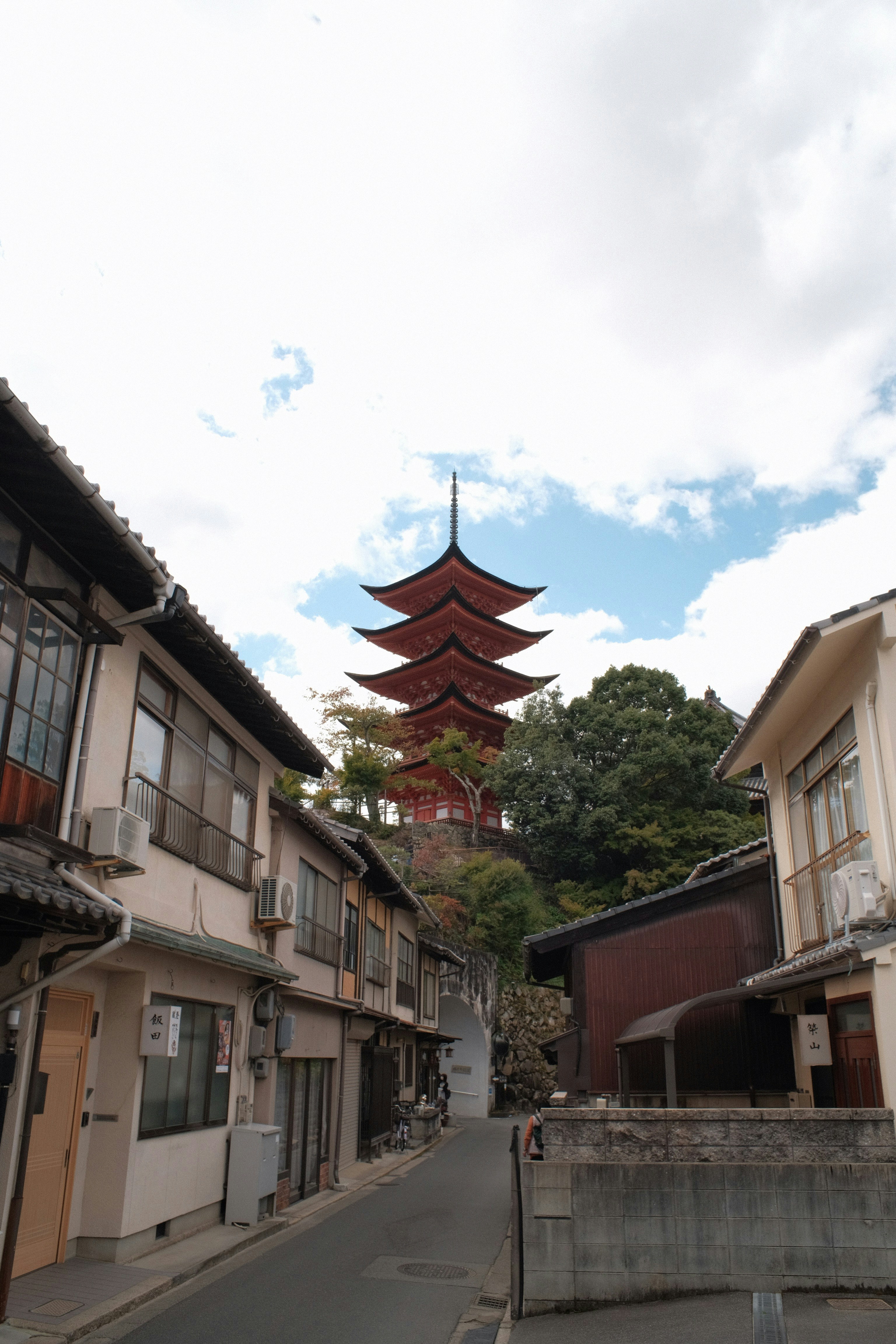 a street with buildings and a pagoda in the background