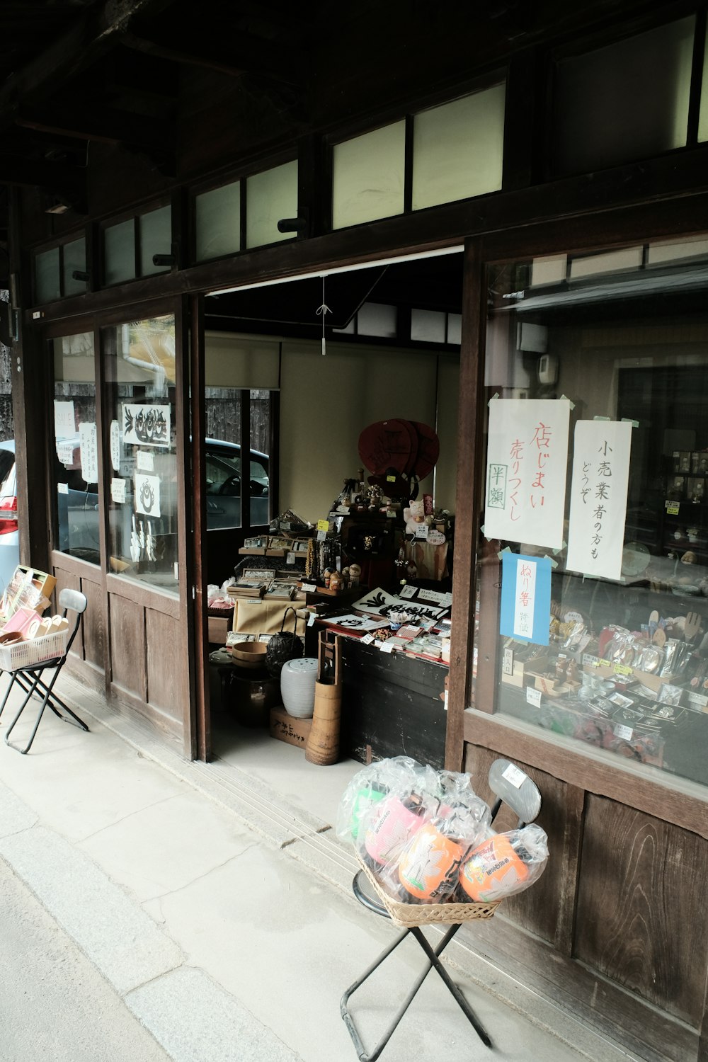 a store front with a chair outside of it