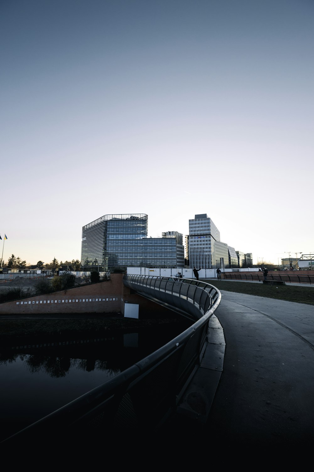 a bridge over a body of water with buildings in the background