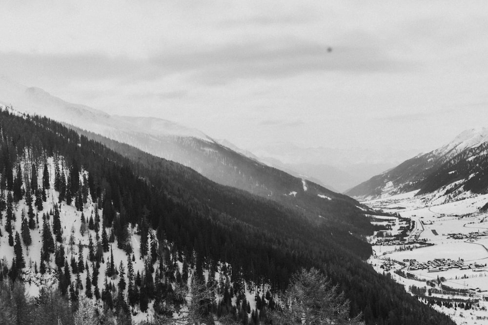 a black and white photo of a snowy mountain