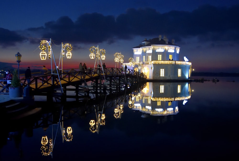 a pier with lights reflecting in the water
