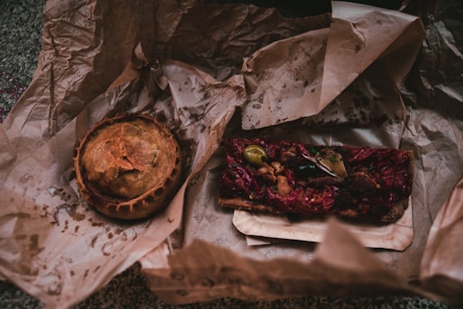a table topped with a pie and a pastry