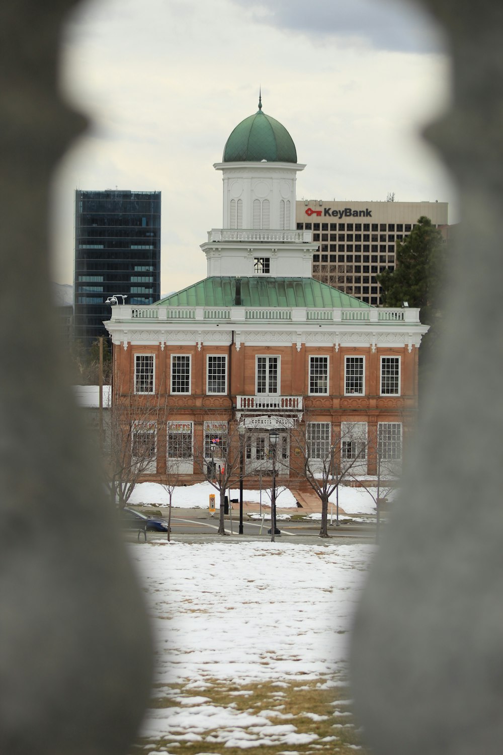 a view of a building through a fence