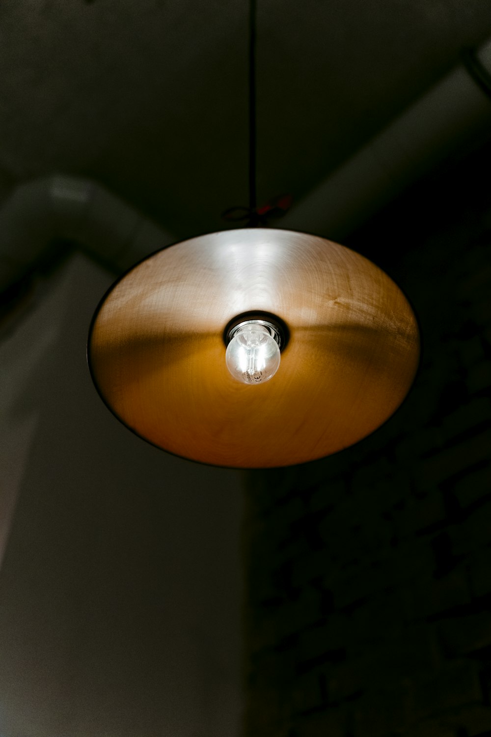 a close up of a light hanging from a ceiling