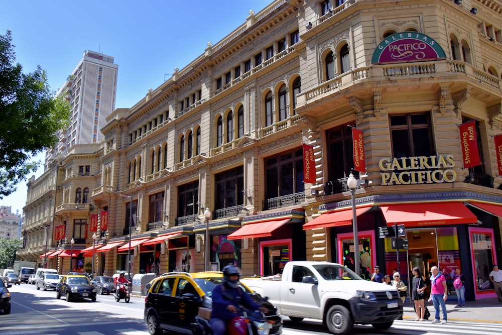 a busy city street with cars, motorcycles and pedestrians